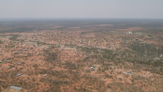 CAP_026_081 - HD stock footage aerial video of flying by a village surrounded by savanna, Botswana