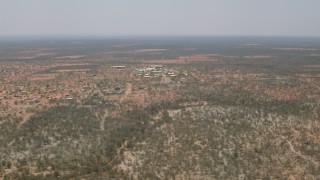 CAP_026_082 - HD stock footage aerial video of passing by a village surrounded by savanna, Botswana