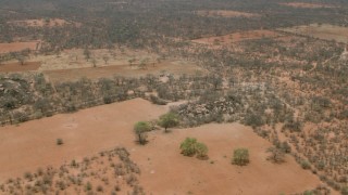 CAP_026_083 - HD stock footage aerial video of orbiting a field near the village, Botswana