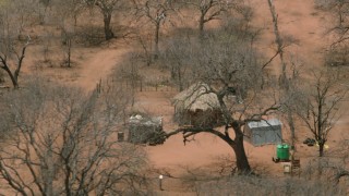 CAP_026_084 - HD stock footage aerial video of orbiting a wooden hut in the village, Botswana