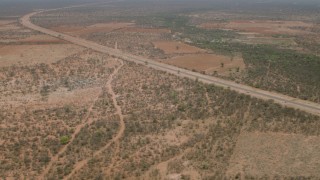 CAP_026_091 - HD stock footage aerial video of approaching a road outside the village, Botswana