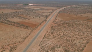 CAP_026_092 - HD stock footage aerial video approach and tilt to a bird's eye of the road outside the village, Botswana