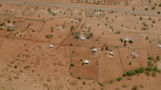 CAP_026_105 - HD stock footage aerial video of circling homes in a village near the road in Zimbabwe