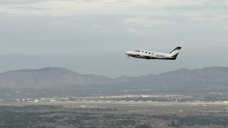 CBAX01_012 - HD aerial stock footage of tracking Cessna 340 ascending on hazy day, Perris, California