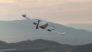CBAX01_014 - HD aerial stock footage of fly by farmland, reveal Cessna 340 ascend, hazy, Perris, California