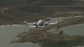 CBAX01_027 - HD aerial stock footage of tracking Cessna 340 over Lake Mathews on a hazy day, Perris, California
