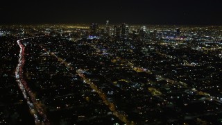 DCA01_009 - 5K stock footage aerial video tilt up revealing downtown Los Angeles skyline at night, California