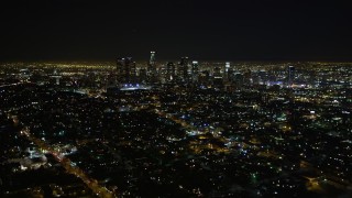 DCA01_010 - 5K stock footage aerial video flying by downtown Los Angeles skyline at night, California