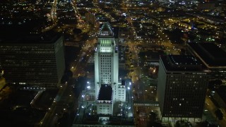 DCA01_026E - 5K stock footage aerial video flying away from Los Angeles City Hall at night, California