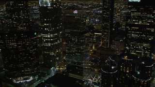 DCA01_055 - 5K stock footage aerial video flying by skyscrapers and public library in downtown Los Angeles at night, California