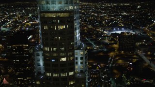 DCA01_056 - 5K stock footage aerial video flying by skyscrapers and buildings in Downtown Los Angeles at night, California