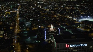 DCA01_058E - 5K stock footage aerial video flying by Downtown Los Angeles office towers at night, California