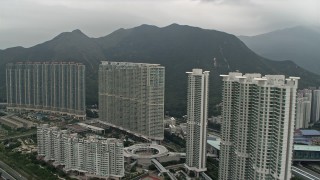 DCA02_003 - 4K aerial stock footage flyby apartment complexes in Tung Chung, Lantau Island, Hong Kong, China