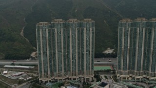 DCA02_004 - 4K aerial stock footage flyby Caribbean Coast apartment complex in Tung Chung, Lantau Island, Hong Kong, China