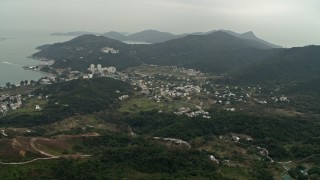 DCA02_005 - 4K aerial stock footage of the small coastal town of Mui Wo on Lantau Island, Hong Kong, China