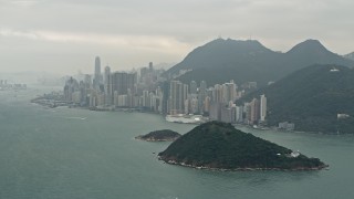 DCA02_012 - 4K aerial stock footage of Victoria Harbor and skyscrapers on Hong Kong Island, China
