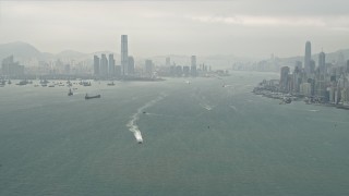 DCA02_013 - 4K aerial stock footage of ships sailing Victoria Harbor near Kowloon, Hong Kong, China