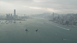 DCA02_014 - 4K aerial stock footage of ships sailing Victoria Harbor between Kowloon and Hong Kong Island, China