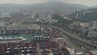 DCA02_017 - 4K aerial stock footage tilt from Port of Hong Kong to reveal Kwai Chung apartment buildings, Hong Kong, China