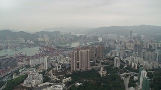 DCA02_019 - 4K aerial stock footage pan from Rambler Channel across Kwai Chung apartment complexes, Hong Kong, China