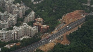 DCA02_027 - 4K aerial stock footage of light traffic on Tolo Highway by apartment buildings in the New Territories, Hong Kong, China