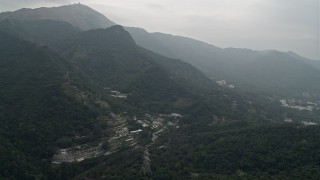 DCA02_029 - 4K aerial stock footage of botanical garden at the base of mountains in the New Territories, Hong Kong, China