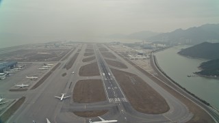 DCA02_047E - 4K aerial stock footage of airliner racing down the runway at Hong Kong International Airport, Hong Kong, China
