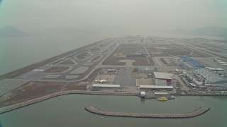 DCA02_049 - 4K aerial stock footage of maintenance buildings and runways at Hong Kong International Airport, Hong Kong, China