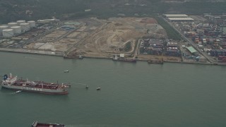 DCA02_055 - 4K aerial stock footage of oil tanker near cargo containers at Pillar Point port, New Territories, Hong Kong, China