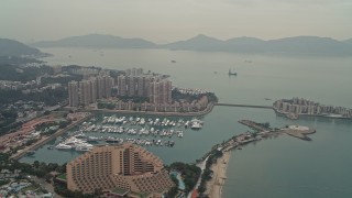 DCA02_061 - 4K aerial stock footage flyby Hong Kong Gold Coast Hotel, marina, and waterfront apartment high-rises in New Territories, Hong Kong, China