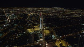 DCA03_001 - 4K aerial stock footage approaching Stratosphere with city sprawl in background, Las Vegas, Nevada Night