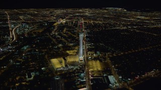 DCA03_002 - 4K aerial stock footage approaching Stratosphere with city sprawl in background, Las Vegas, Nevada Night