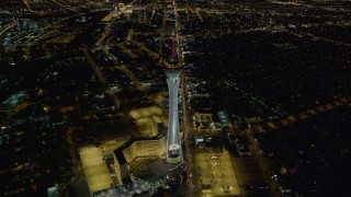 DCA03_003 - 4K aerial stock footage video of approaching Stratosphere, Las Vegas, Nevada Night