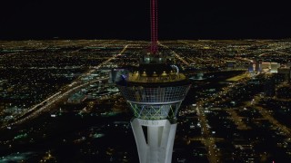 DCA03_008 - 4K aerial stock footage of orbiting top of Stratosphere with city sprawl in background, Las Vegas, Nevada Night