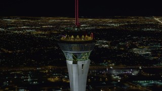 DCA03_009 - 4K aerial stock footage of orbiting top of Stratosphere with city sprawl in background, Las Vegas, Nevada Night