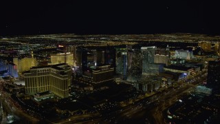 DCA03_022 - 4K aerial stock footage of the back of The Bellagio, Aria Resort, Paris, Planet Hollywood, Las Vegas, Nevada Night