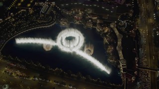 DCA03_025 - 4K aerial stock footage of flying away from Bellagio Fountain water show, revealing The Bellagio, Las Vegas, Nevada Night