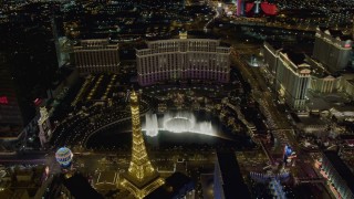 DCA03_026 - 4K stock footage aerial video of Bellagio Fountain water show between Bellagio and Paris, Las Vegas, Nevada Night