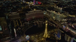 DCA03_027 - 4K aerial stock footage of The Bellagio Fountain between The Bellagio and Paris, Las Vegas, Nevada Night