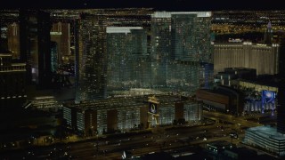 DCA03_048 - 4K aerial stock footage of descending toward parking garage near Aria Resort, Las Vegas, Nevada Night