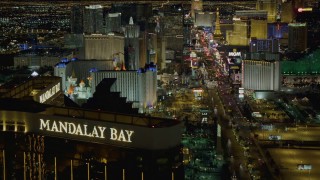 DCA03_056 - 4K stock footage aerial video of Las Vegas Blvd from Mandalay Bay to MGM Grand, reveal Excalibur, New York New York, Las Vegas, Nevada Night