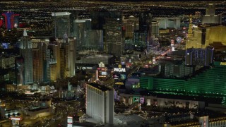 DCA03_057 - 4K aerial stock footage of flying by New York New York, Aria, MGM Grand, Las Vegas, Nevada Night
