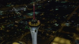 DCA03_082 - 4K aerial stock footage of orbiting top of Stratosphere, Las Vegas, Nevada Night