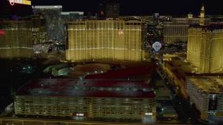 DCA03_168 - 4K aerial stock footage of flying behind Planet Hollywood, Paris and Bally's, Las Vegas, Nevada Night