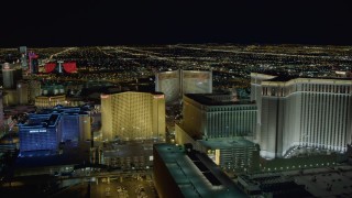 DCA03_170 - 4K aerial stock footage of flying behind Imperial Palace and Harrah's, Las Vegas, Nevada Night