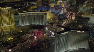 DCA03_174 - 4K aerial stock footage of hotels along Las Vegas Boulevard, including Treasure Island, Nevada Night