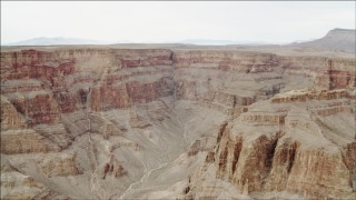 DCA04_032 - 4K aerial stock footage of a dry riverbed in Grand Canyon, Arizona, and tilt to steep cliffs
