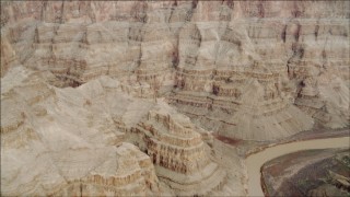 DCA04_033 - 4K aerial stock footage of a bend in the Colorado River in Grand Canyon, Arizona, and tilt to the cliff face