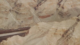 DCA04_056 - 4K aerial stock footage of panning across rock formations in Grand Canyon, revealing Colorado River, Arizona