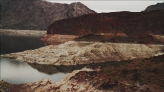 DCA04_065 - 4K aerial stock footage of flying by foothills and over shore of Lake Mead, Nevada